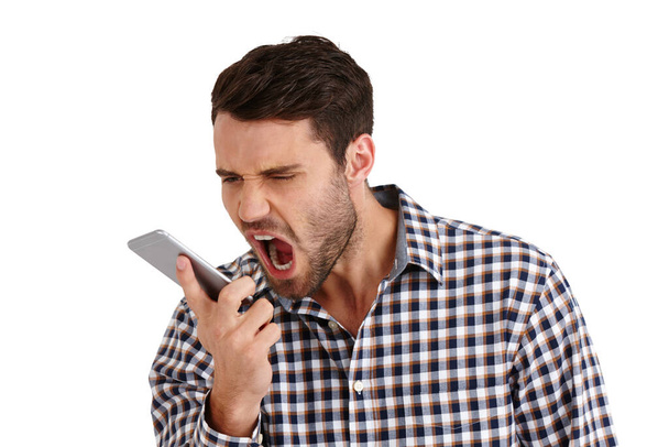 No. Studio shot of a young man shouting into his cellphone isolated on white - Foto, Imagem
