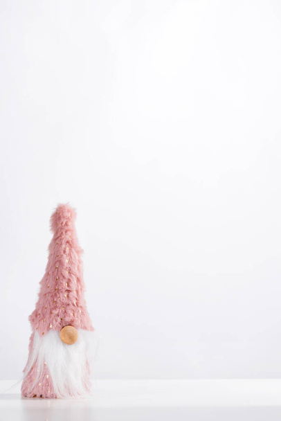 Scandinavian gnome in pink hat decorative christmas toy isolated on white background, - Foto, afbeelding