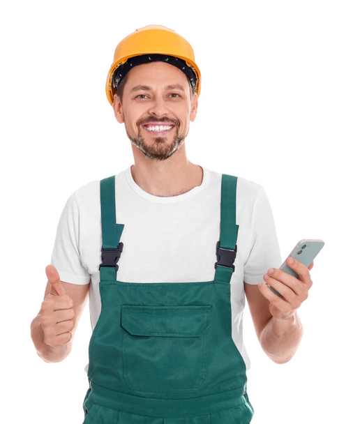Professional repairman in uniform with phone on white background - Foto, afbeelding