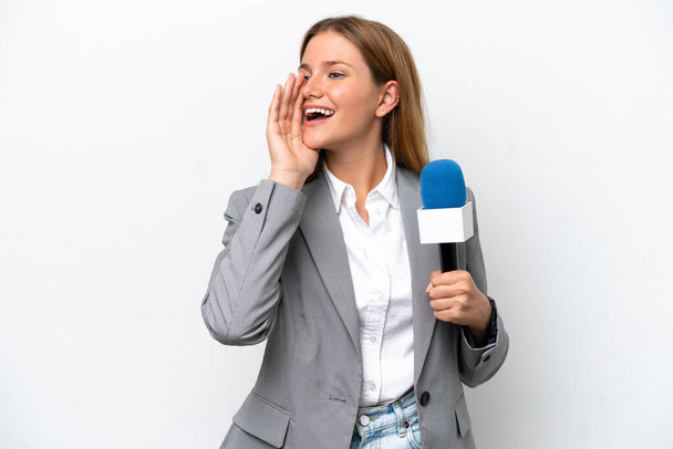 Young caucasian tv presenter woman isolated on white background shouting with mouth wide open to the side - Photo, Image