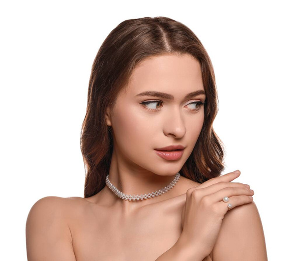 Young woman wearing elegant pearl jewelry on white background - Zdjęcie, obraz