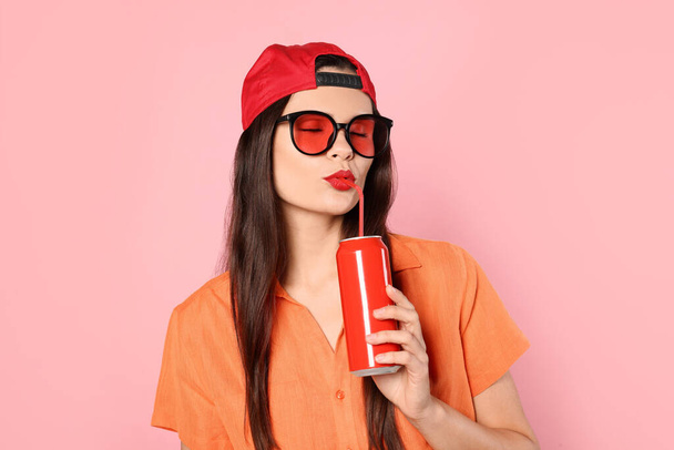 Beautiful young woman drinking from tin can on pink background - Φωτογραφία, εικόνα