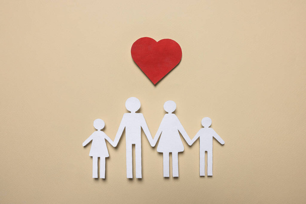 Paper family figures and red heart on beige background, flat lay. Insurance concept - Foto, afbeelding