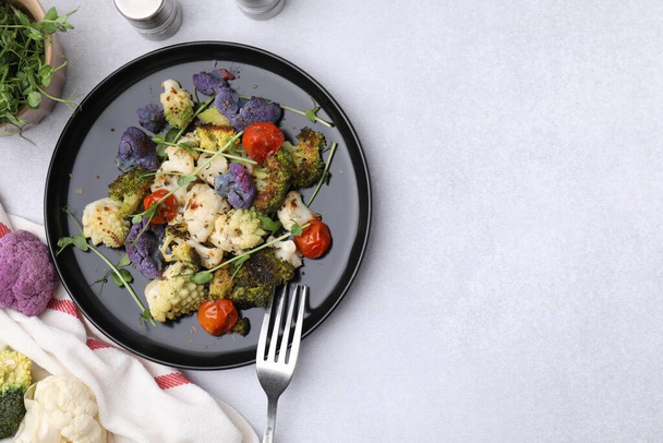 Delicious salad with cauliflower and tomato served on white table, flat lay. Space for text - Φωτογραφία, εικόνα