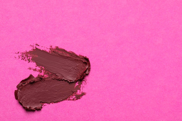 Smears of beautiful lipstick on pink background, top view. Space for text - Fotó, kép
