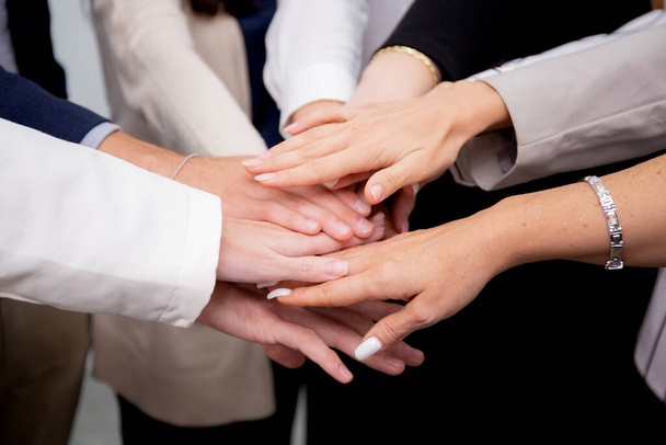 Group of business team harmonious with man and woman joining hands stack together in enterprise for victory and success, teamwork of partnership with meeting and cheering for achievement. - Photo, Image