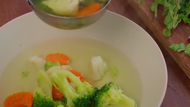 close up με σούπα με καρότο λαχανικών, πιάτο μπρόκολο στο τραπέζι χορτοφαγικό γεύμα - Πλάνα, βίντεο