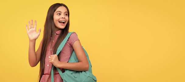 hello knowledge day. concept of education. kid with long hair on yellow background. Portrait of schoolgirl student, studio banner header. School child face, copyspace - Photo, image