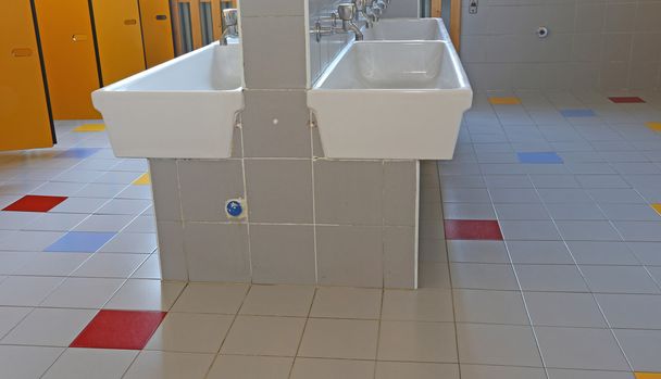 banheiro da escola de quarto de crianças com portas amarelas
 - Foto, Imagem