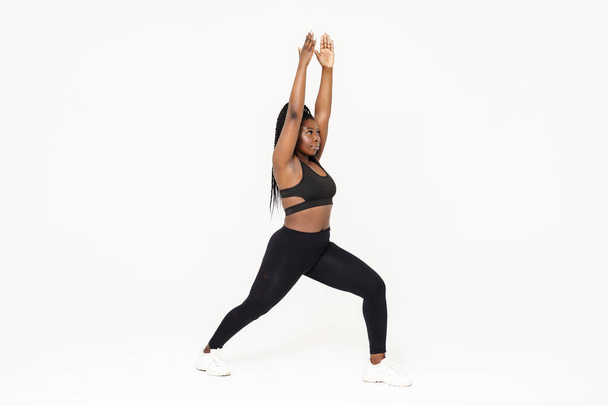 Black young woman doing exercise while working out isolated over white background - Photo, Image