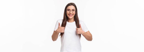 Good idea, lets do it. Enthusiastic smiling caucasian woman in glasses, fully support your plan, show thumbs-up and nod in approval, grinning positive reply, like and encourage keep going. - Photo, Image