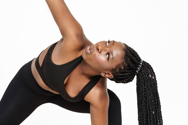 Black young woman doing exercise while working out isolated over white background - Photo, Image