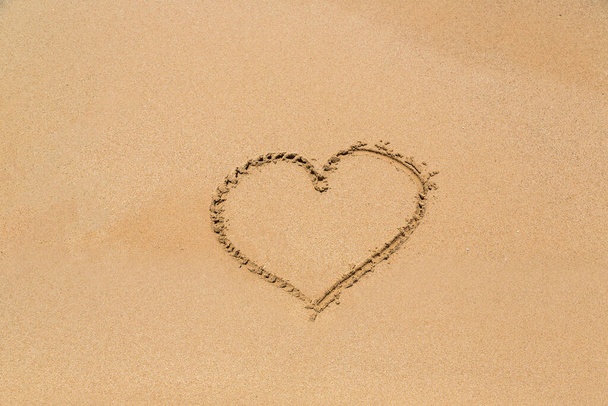 Heart symbol written in a sandy on tropical beach - Fotó, kép