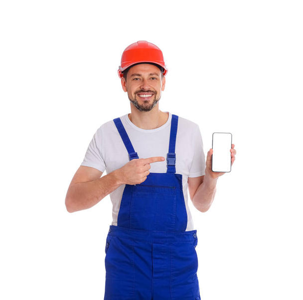 Professional repairman in uniform with phone on white background - Fotografie, Obrázek