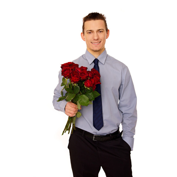 Young man holds bouquet of red roses - Foto, afbeelding