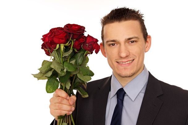 Man holds bouquet of red roses - Фото, зображення