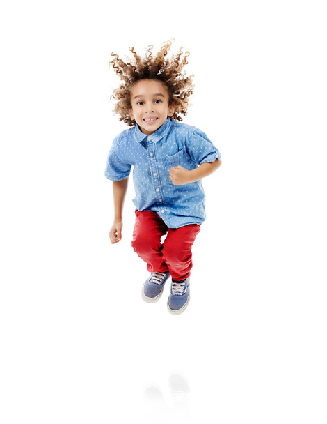 Jumping for joy is the best way to exercise. Studio shot of a cute little boy jumping for joy against a white background - Φωτογραφία, εικόνα