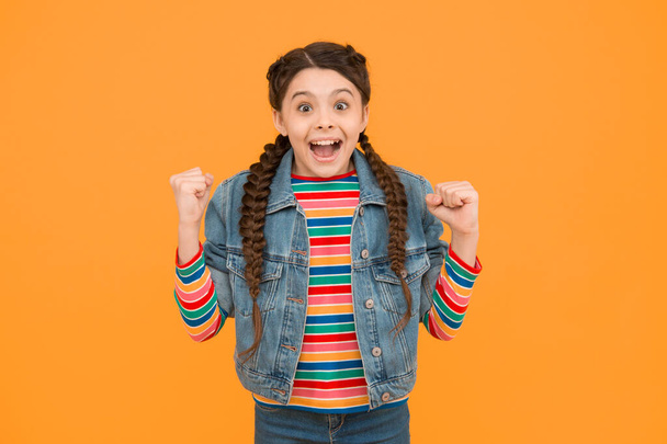 Happy little girl with braids wear denim clothes, excited about sale concept. - 写真・画像