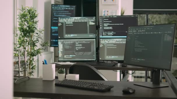 Деск з декількома моніторами, що відображають вікно термінала та код програмування штучного інтелекту. Порожній офіс агентства розробки програмного забезпечення з хмарними обчисленнями серверів, html скрипт
. - Кадри, відео
