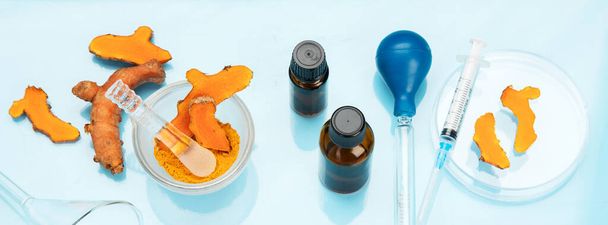Medicine research of curcuma properties with the help of laboratory equipment, woman in gloves testing turmeric powder. Top view. Panorama - Foto, afbeelding