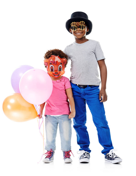 Fancy dress fun. Studio shot of two young friends dressed up for a party against a white background - Foto, immagini