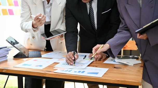 cropped image, Group of professional executive manager in formal business suit brainstorming and working on financial data graph and chart report together in the meeting. - Photo, Image