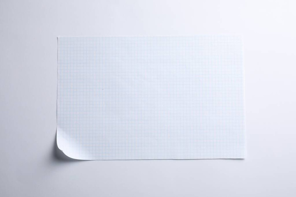Checkered sheet of paper on white background, top view - Φωτογραφία, εικόνα