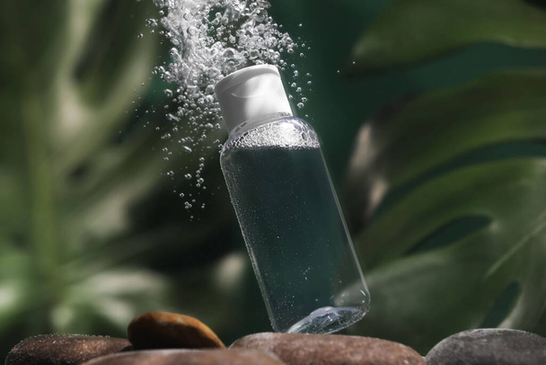 Bottle of micellar water in liquid on blurred background - Foto, Imagem