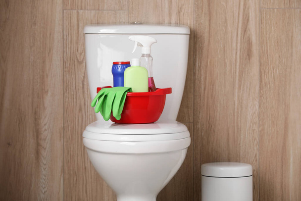 Different cleaning supplies on toilet bowl indoors - Fotografie, Obrázek