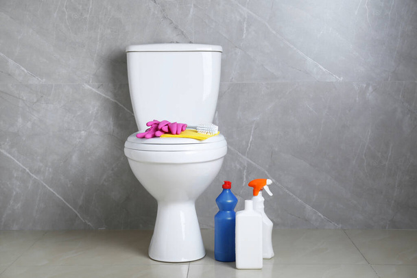 Toilet bowl and different cleaning supplies indoors - Photo, Image