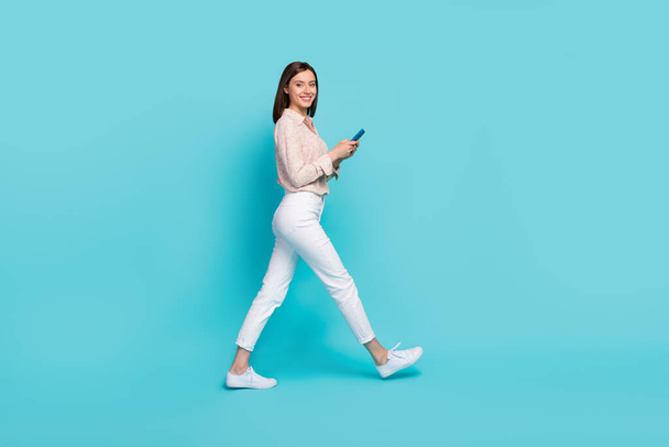 Full length photo of positive lady manager stylish clothes hurry work use gms map navigation empty space isolated on cyan color background. - Foto, Imagem