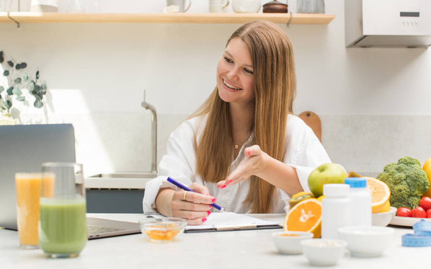 Attractive female nutritionist holding an online consultation with a patient. Healthy food, healthy lifestyle. - Photo, image