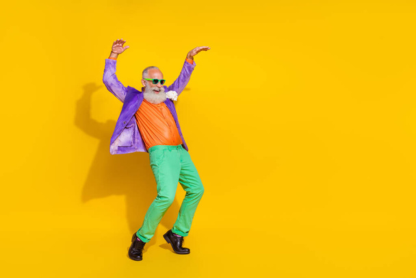 Full body photo of handsome grandparent have fun dancing tiptoes cheerful wear trendy colorful clothes isolated on yellow color background. - Φωτογραφία, εικόνα