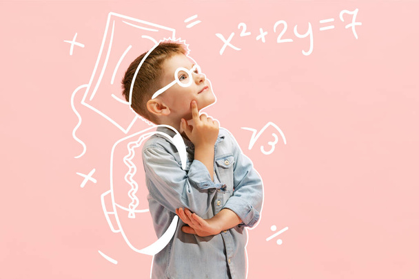 Creative design with drawn elements. Little thoughtful boy counting mathematics over pink background. Developing knowledge. Concept of imagination, childhood, motherhood, creativity, dreams, ad - Photo, Image