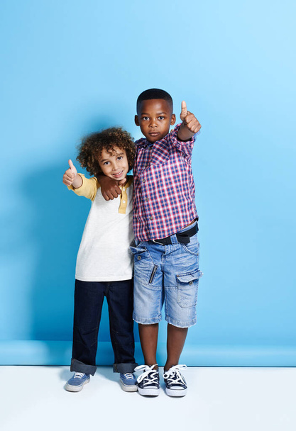 Friends uplift the soul. two young boys showing thumbs up towards the camera - Foto, afbeelding
