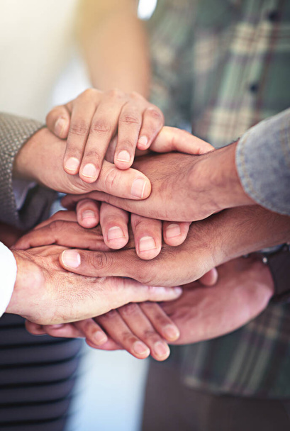 Lets do this as a team. Closeup shot of a group of coworkers with their hands in a huddle - Foto, imagen