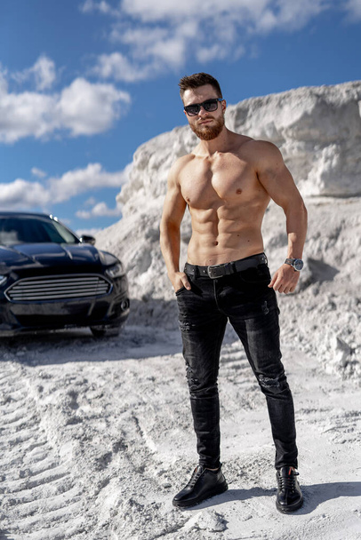 Athletic strong bodybuilder model. Shirtless young muscular man outdoor posing. - Fotoğraf, Görsel