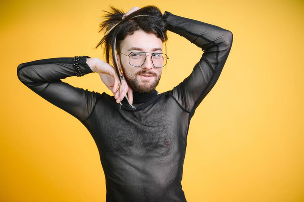 Young gay man is standing in the studio and posing for a camera - Fotó, kép