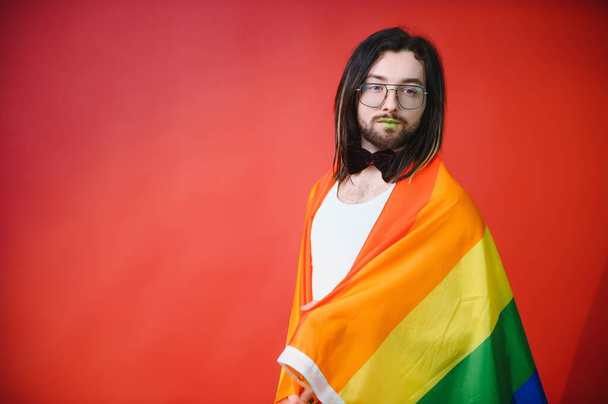 Youth transgender LGBT with Rainbow flag on shoulder isolated color background. gender expression pride and equality concept - Φωτογραφία, εικόνα