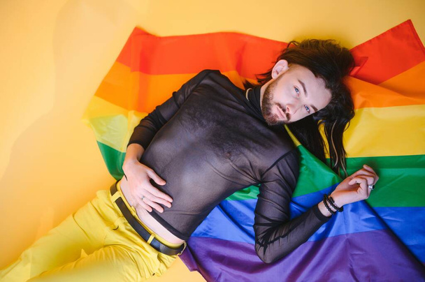 Youth transgender LGBT with Rainbow flag on shoulder isolated color background. gender expression pride and equality concept - Foto, Imagem