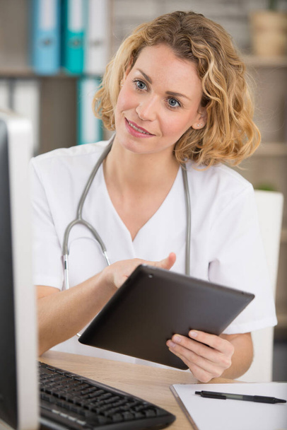 woman doctor with tablet at the office - Photo, image