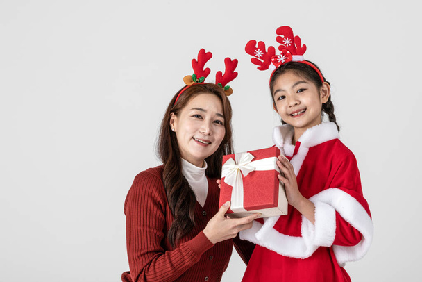 happy Asian Korean family in Christmas concept, little girl received gift - Photo, Image