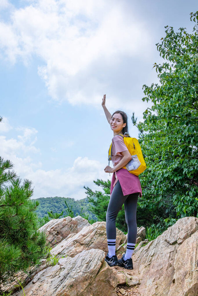 korean young woman hiker on the rock - Fotoğraf, Görsel