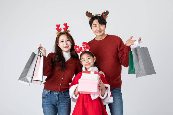 happy Asian Korean family in Christmas concept, holding gifts - Fotografie, Obrázek