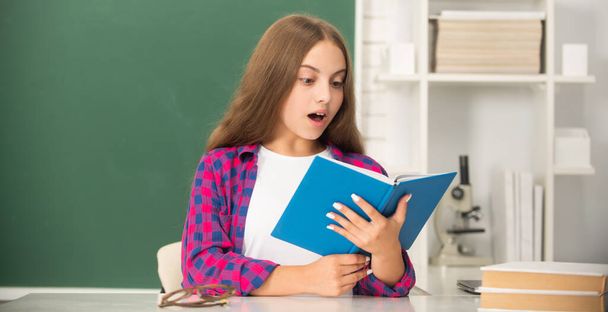 surprised teenager student. modern education. high school. schoolgirl with copybook. child read notebook. back to school. teen girl ready to study. kid do homework with book. - Photo, Image