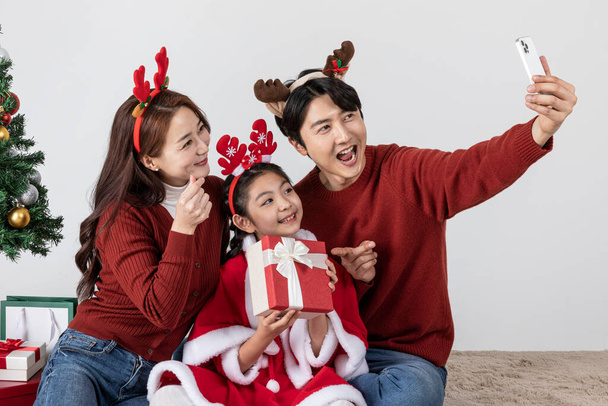 happy Asian Korean family in Christmas concept, making selfie - Photo, image