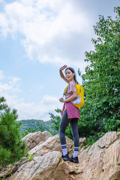 korean young woman hiker on the rock - Fotoğraf, Görsel