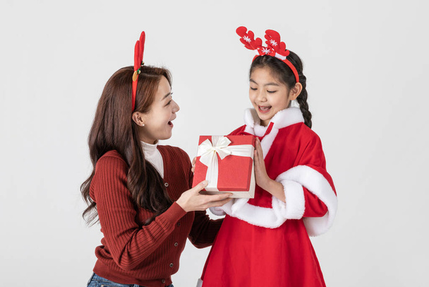 happy Asian Korean family in Christmas concept, little girl received gift - Fotó, kép