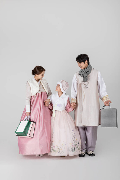 Korean family in Hanbok, against white studio white background - Фото, изображение