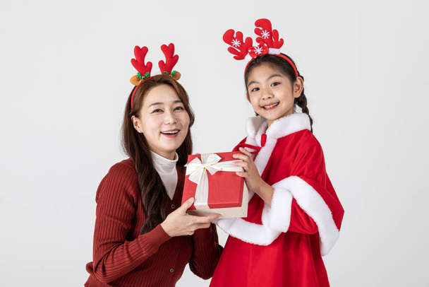 happy Asian Korean family in Christmas concept, little girl received gift - Photo, image